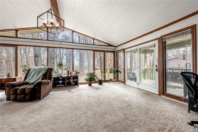 sunroom featuring a notable chandelier, lofted ceiling, and a healthy amount of sunlight