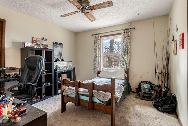 bedroom featuring a textured ceiling, carpet floors, and a ceiling fan