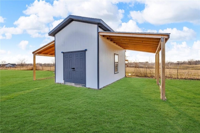 view of outdoor structure with a carport and an outbuilding