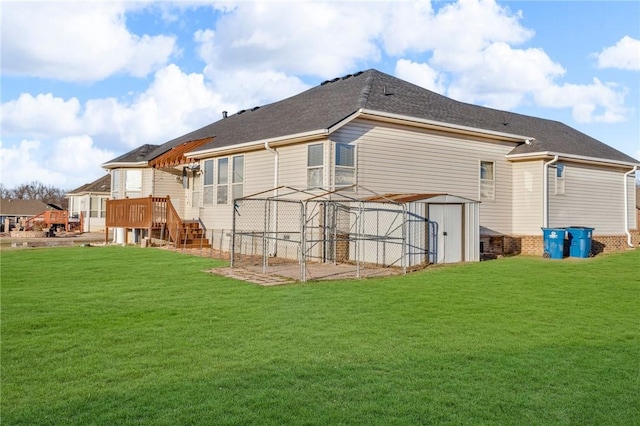 rear view of property featuring a storage shed, a lawn, and an outdoor structure