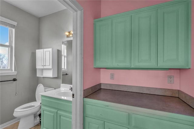 bathroom featuring toilet and vanity