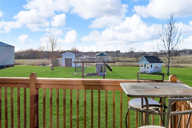 view of yard featuring a playground and an outdoor structure