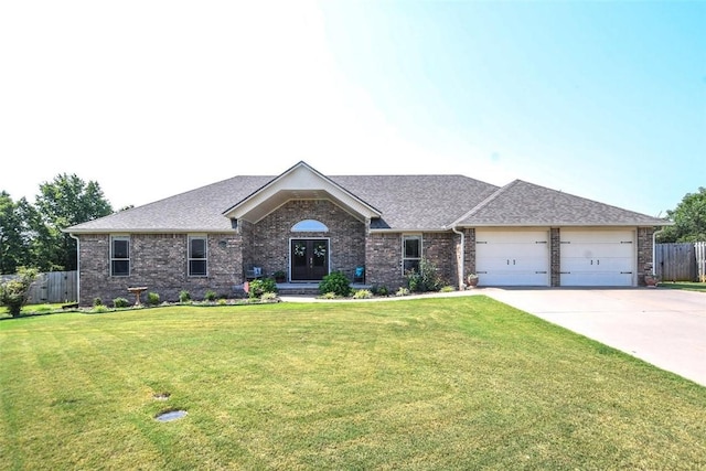 single story home with an attached garage, fence, concrete driveway, french doors, and a front lawn