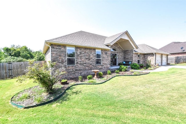 view of front of house with fence, a front lawn, and brick siding