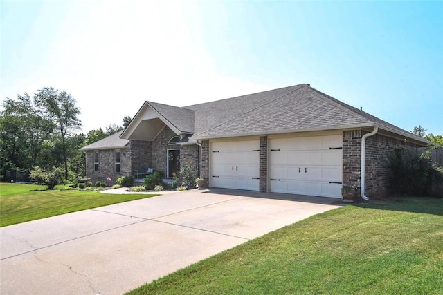 view of front facade featuring a garage, brick siding, driveway, and a front yard