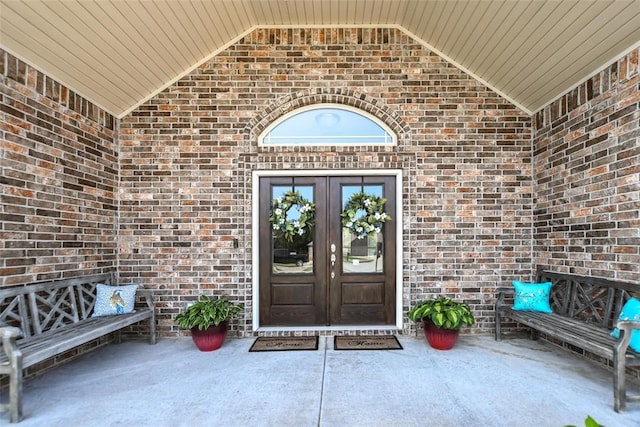 property entrance featuring a patio area and french doors