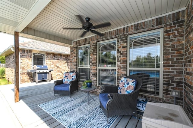 wooden deck featuring ceiling fan and a grill