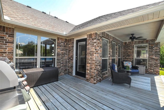 wooden terrace featuring a ceiling fan