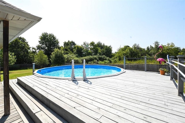 view of swimming pool featuring a deck and a fenced in pool