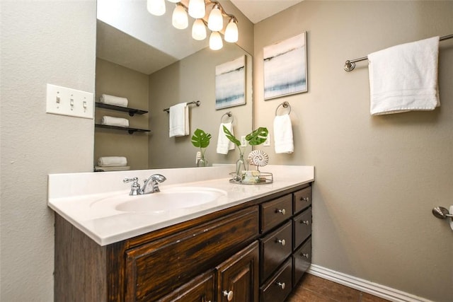 bathroom with tile patterned flooring, vanity, and baseboards