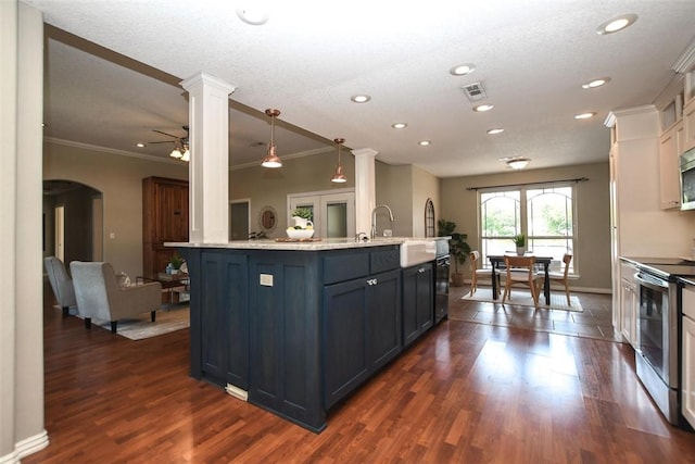 kitchen featuring arched walkways, dark wood-type flooring, visible vents, and stainless steel range with electric stovetop