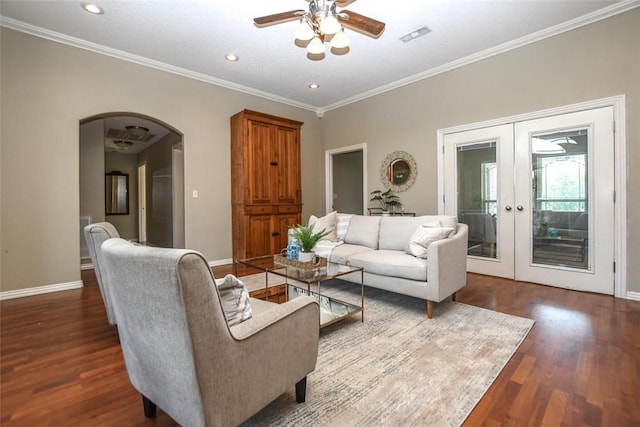 living area with arched walkways, french doors, baseboards, and wood finished floors