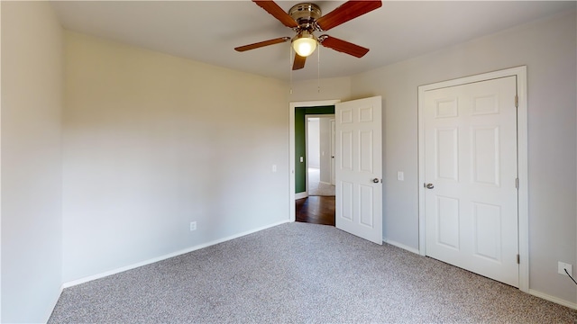 unfurnished bedroom featuring ceiling fan, carpet floors, and baseboards