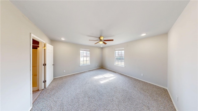 spare room with light carpet, ceiling fan, recessed lighting, and baseboards