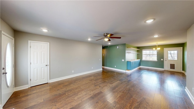 interior space featuring ceiling fan with notable chandelier, recessed lighting, wood finished floors, and baseboards