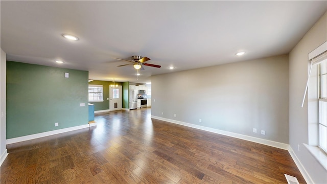 spare room with recessed lighting, dark wood finished floors, baseboards, and ceiling fan