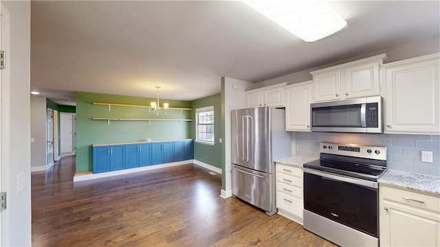 kitchen with tasteful backsplash, appliances with stainless steel finishes, and white cabinets