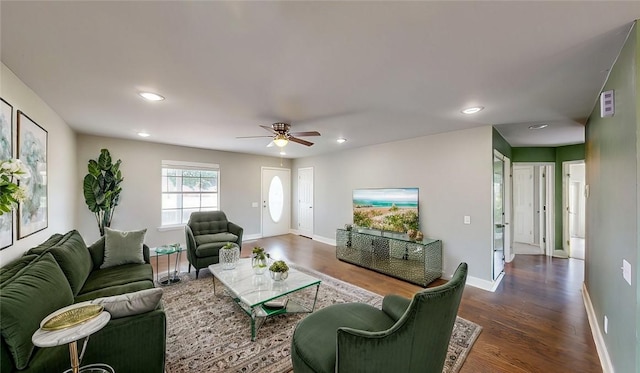 living area with a ceiling fan, recessed lighting, dark wood-style flooring, and baseboards