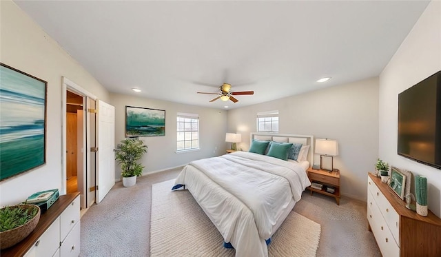 bedroom with a ceiling fan, recessed lighting, light carpet, and baseboards