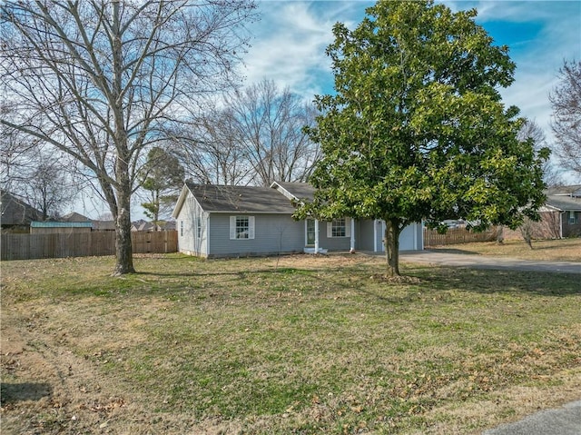 view of front of house featuring a garage, a front yard, fence, and driveway