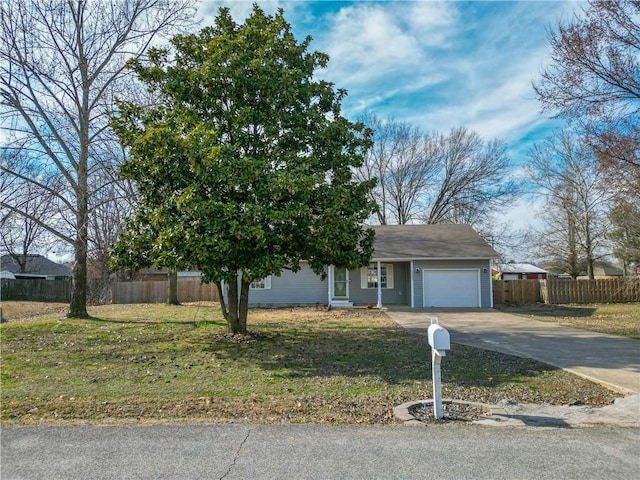 view of front of home with a front lawn, concrete driveway, fence, and an attached garage