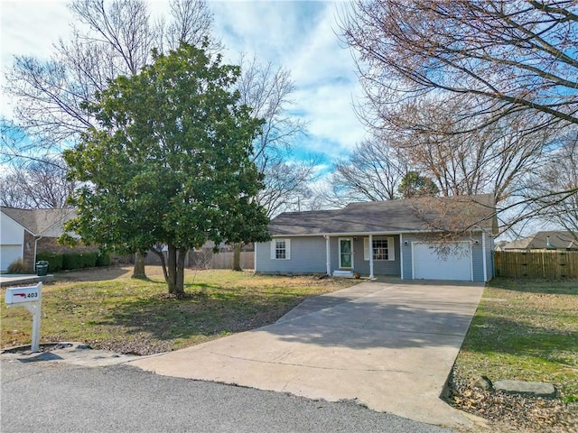 ranch-style home with a garage, fence, a front lawn, and concrete driveway