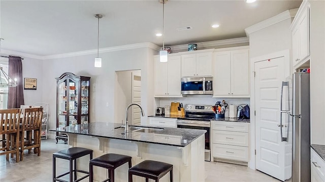 kitchen featuring stainless steel appliances, a sink, white cabinets, backsplash, and crown molding