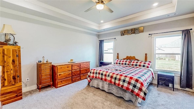 bedroom with a raised ceiling, visible vents, crown molding, and carpet flooring