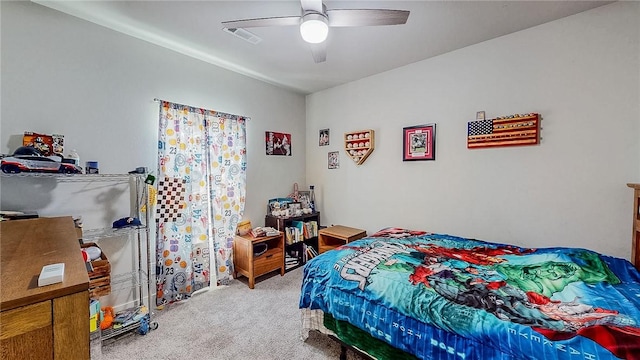 carpeted bedroom with visible vents and a ceiling fan