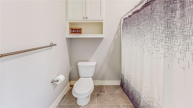 bathroom with baseboards, toilet, and tile patterned floors