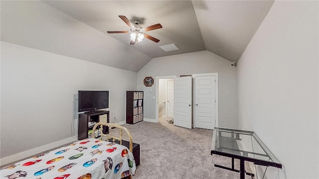 carpeted bedroom featuring a ceiling fan, lofted ceiling, visible vents, and baseboards