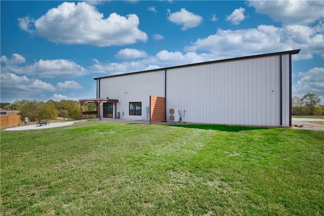 view of pole building with a yard and a pergola