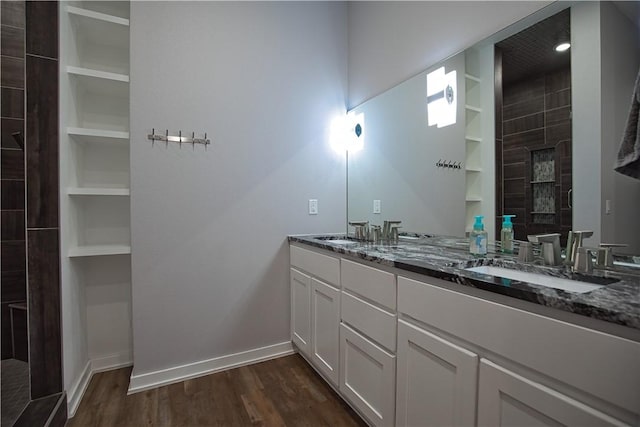 full bath with walk in shower, a sink, and wood finished floors