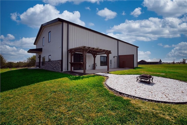 view of outbuilding featuring a fire pit and a pergola