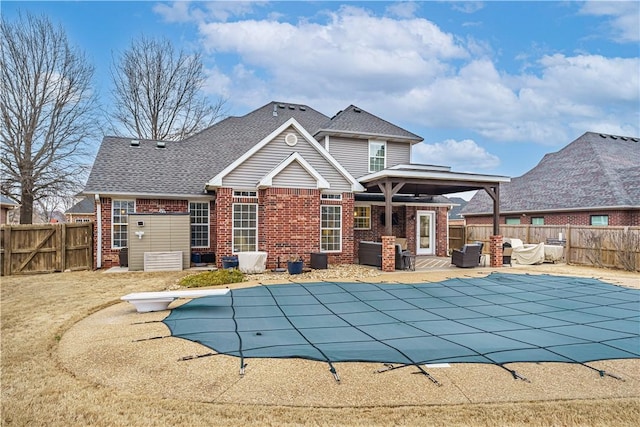 exterior space with a diving board, a fenced in pool, a patio, and a fenced backyard