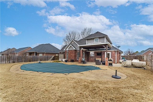 exterior space featuring a patio, a yard, a fenced backyard, and a fenced in pool