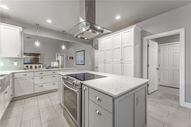 kitchen featuring a kitchen island, island exhaust hood, electric stove, white cabinetry, and tasteful backsplash