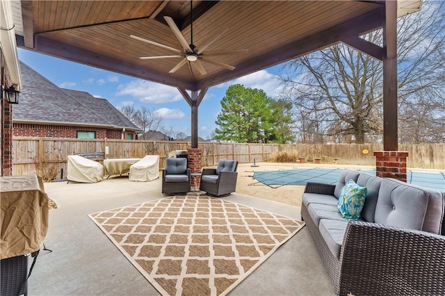 view of patio / terrace featuring an outdoor living space, a ceiling fan, and a fenced backyard