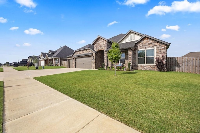 view of front of property with a front yard, fence, driveway, stone siding, and a garage