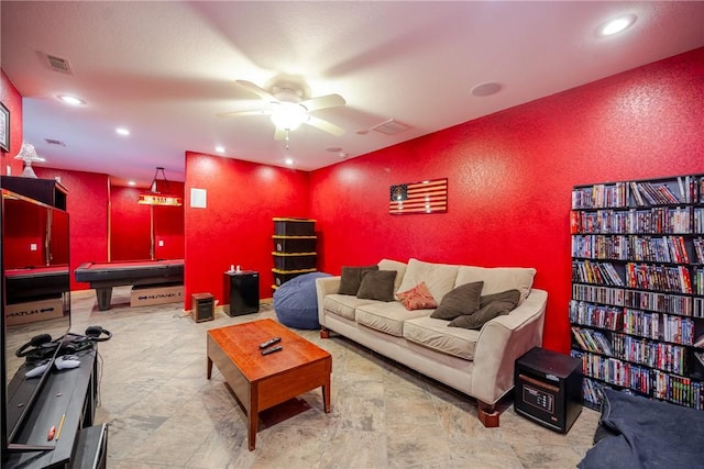 living area with recessed lighting, visible vents, a ceiling fan, and a textured wall