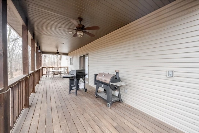 wooden deck featuring ceiling fan, outdoor dining space, and grilling area