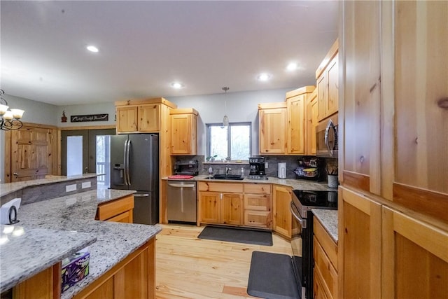 kitchen with stainless steel appliances, french doors, decorative light fixtures, and decorative backsplash