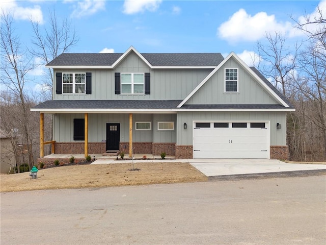 view of front of home featuring brick siding, a porch, a shingled roof, concrete driveway, and a garage