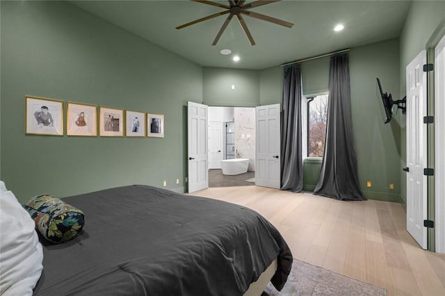 bedroom with recessed lighting, ceiling fan, ensuite bathroom, and wood finished floors