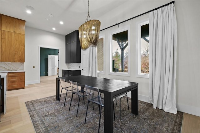 dining room featuring a chandelier, recessed lighting, light wood-type flooring, and baseboards