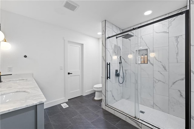 full bath with a marble finish shower, visible vents, toilet, a sink, and baseboards