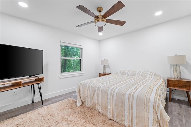 bedroom featuring a ceiling fan, baseboards, wood finished floors, and recessed lighting