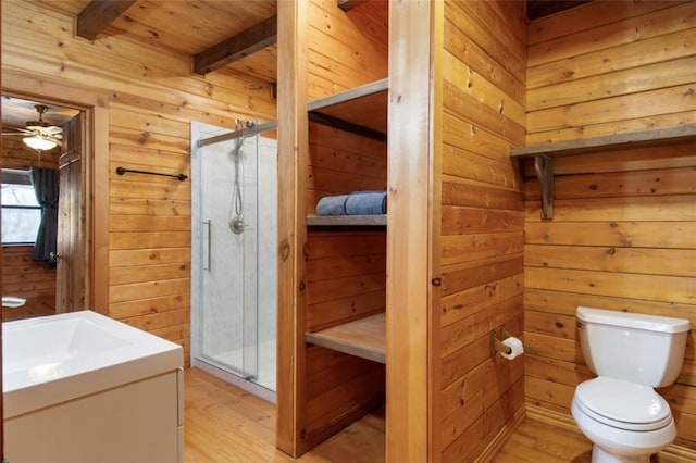 full bath with a stall shower, toilet, and wooden walls