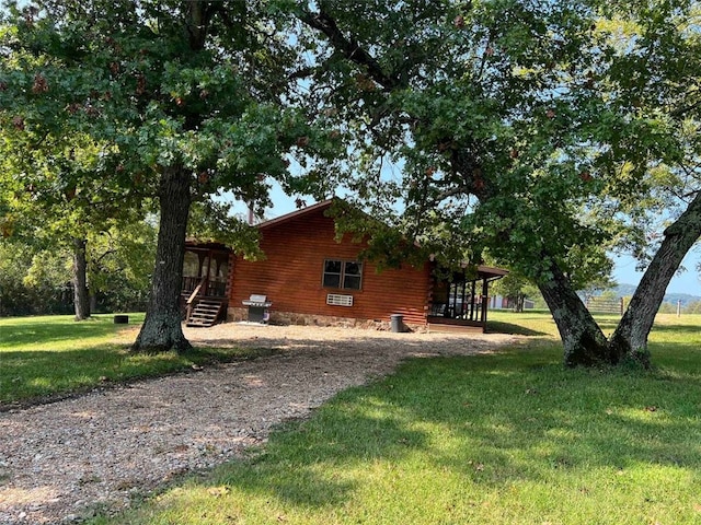 view of home's exterior with a yard and log exterior