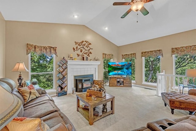 carpeted living area featuring plenty of natural light, vaulted ceiling, and a ceiling fan